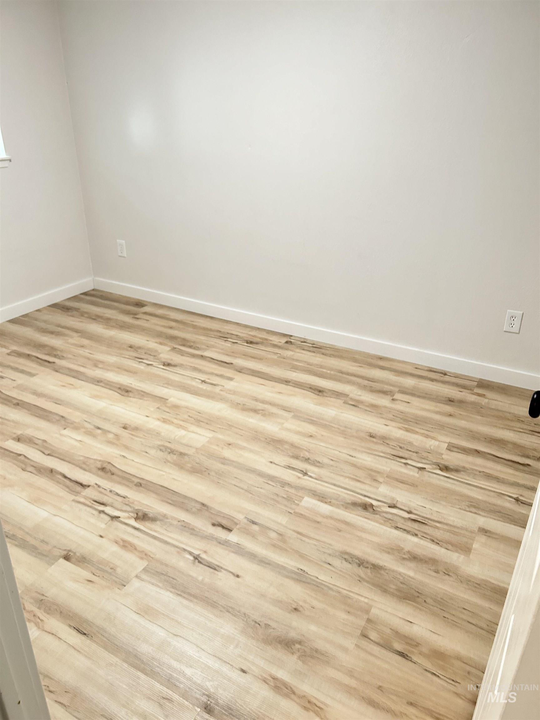3897 South Yorktown Way Boise, ID 83706 - Photo 20 of 23 Empty room with light wood finished floors