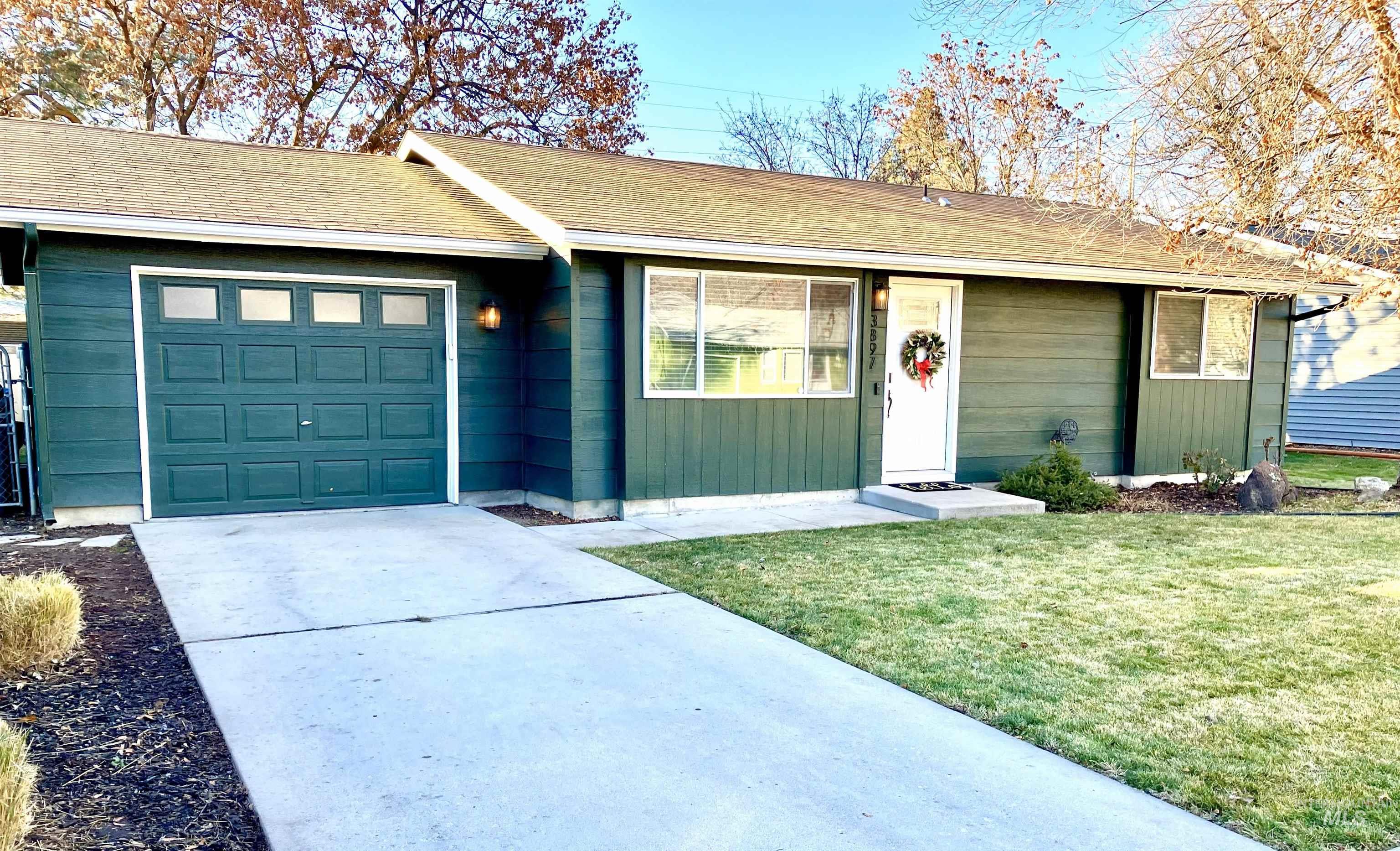 3897 South Yorktown Way Boise, ID 83706 - Photo 2 of 23 Ranch-style house featuring concrete driveway, a front lawn, and an attached garage