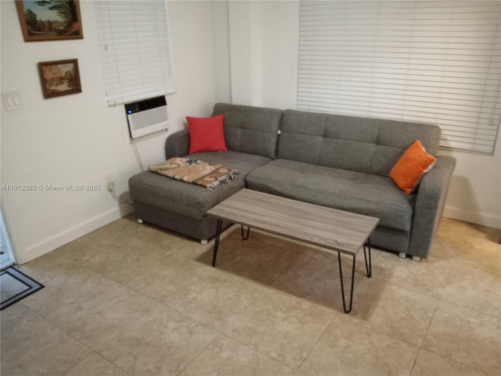1906 Tigertail Avenue Miami, FL 33133 - Photo 4 of 17 a living room with furniture and a window
