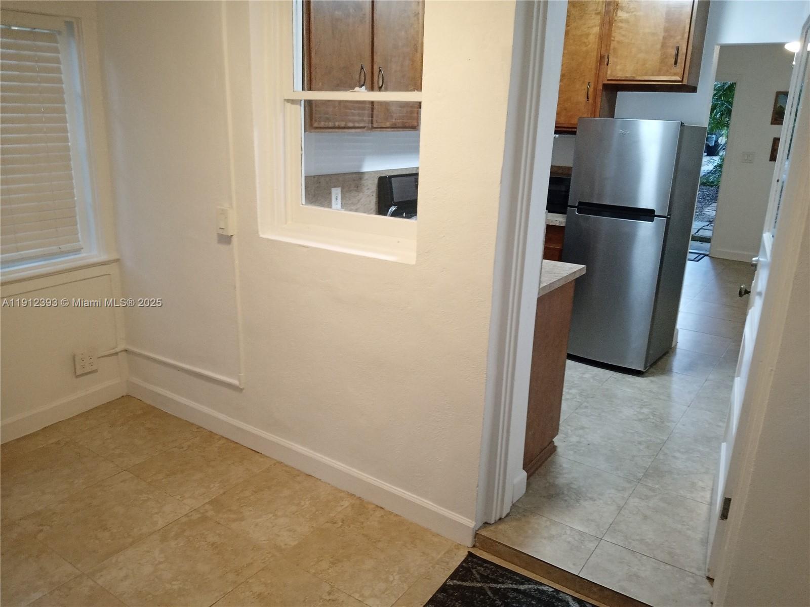 1906 Tigertail Avenue Miami, FL 33133 - Photo 7 of 17 a view of a kitchen with a refrigerator