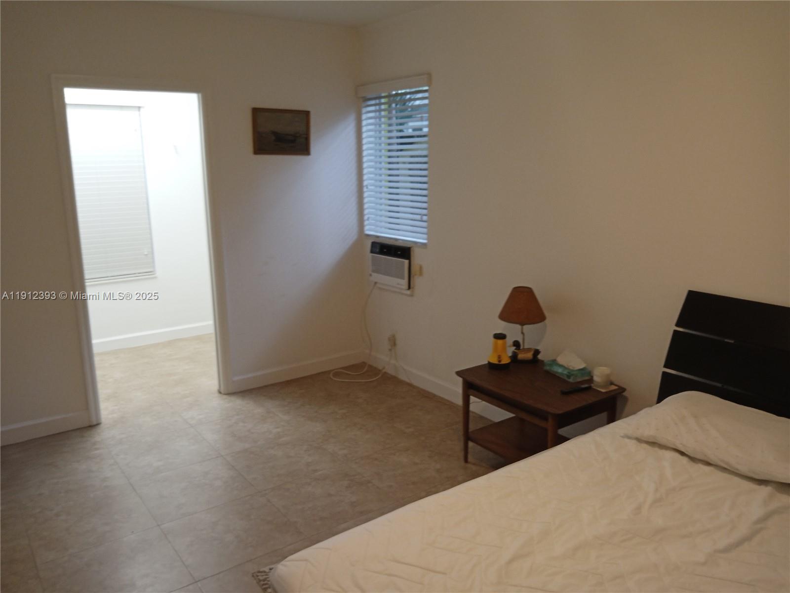 1906 Tigertail Avenue Miami, FL 33133 - Photo 9 of 17 a bedroom with a bed and a window