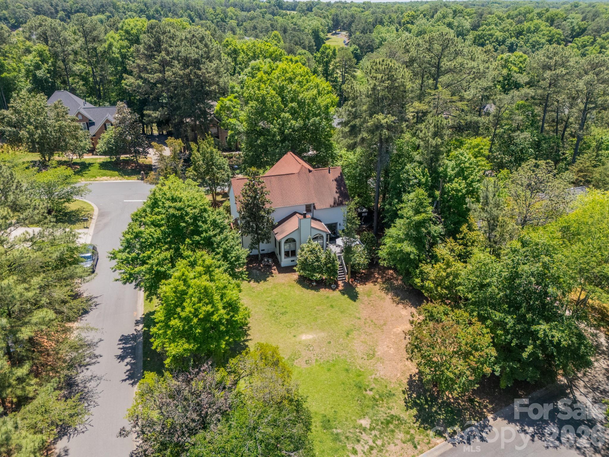11043 Seven Coves Drive Tega Cay, SC 29708 - Photo 3 of 45 an aerial view of a house with a yard and lake view