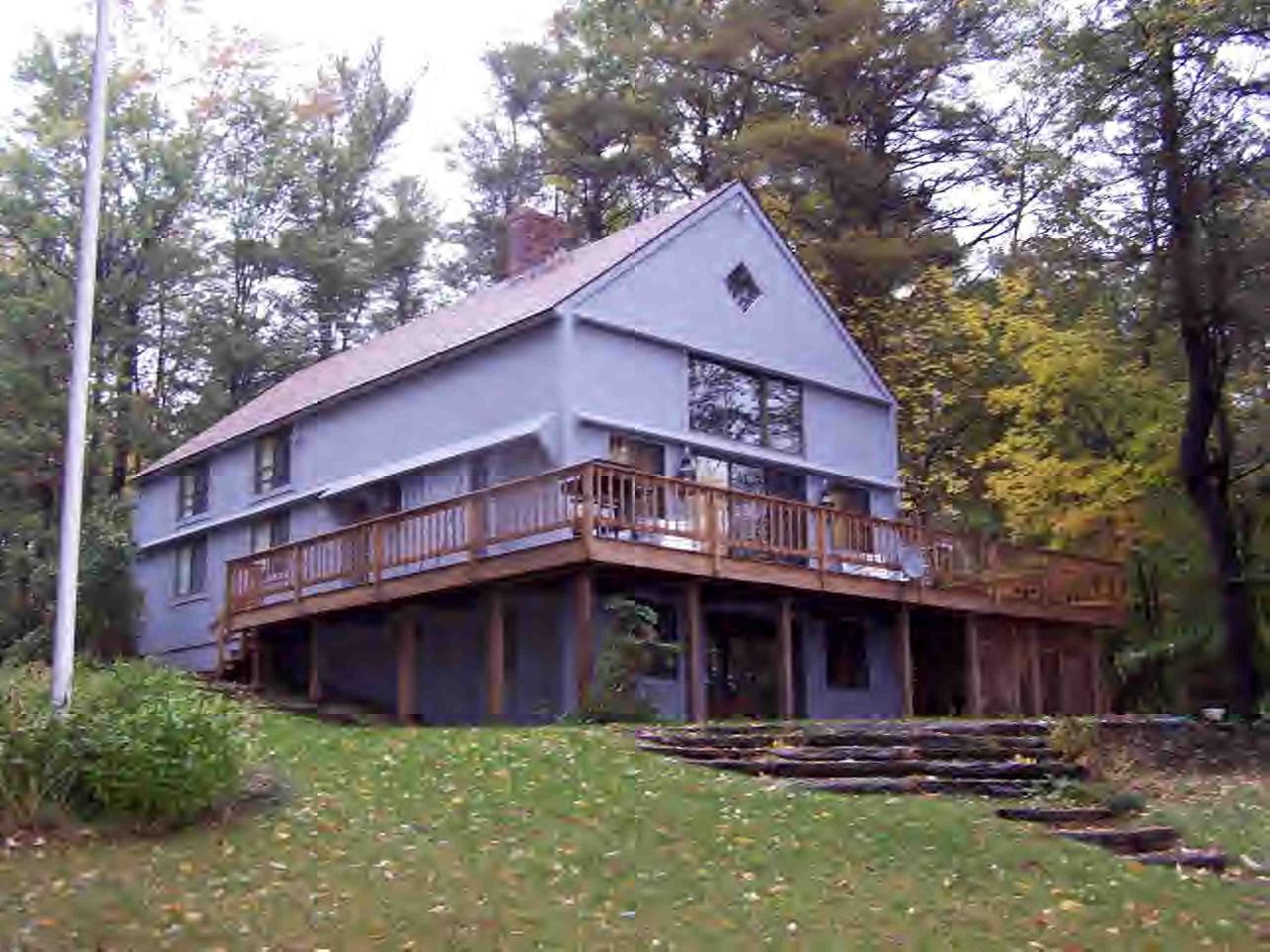 a view of a house with wooden fence