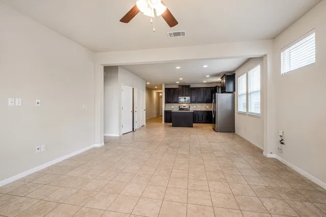 a view of kitchen and refrigerator