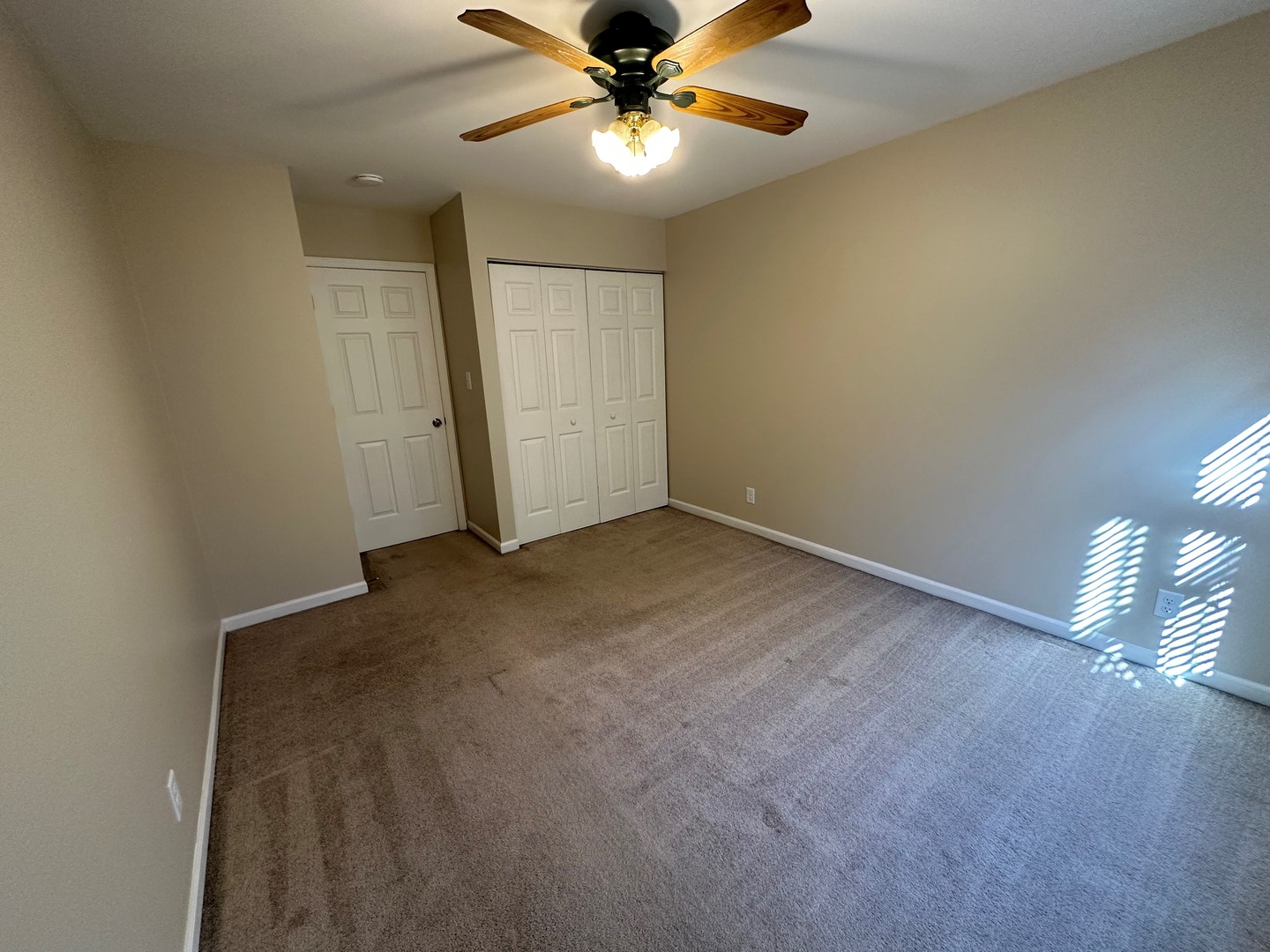 2100 Light Road, Unit 108 Oswego, IL 60543 - Photo 12 of 12 a view of an empty room and window and ceiling fan