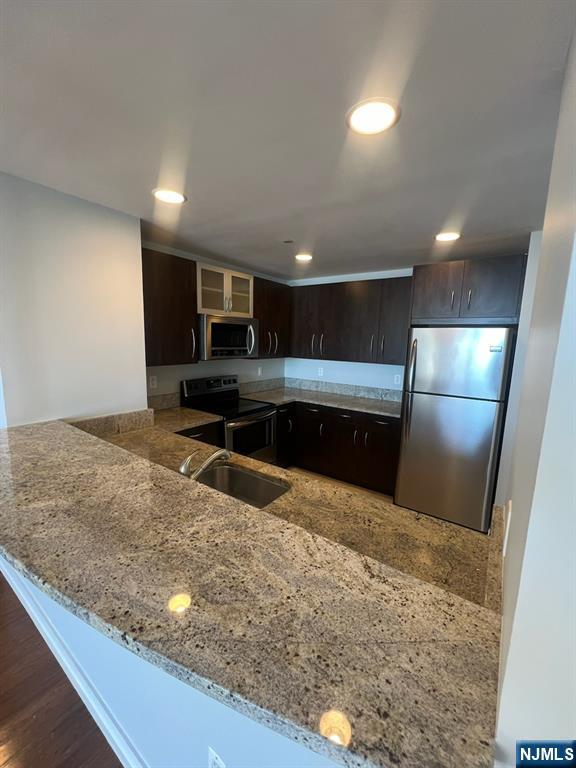 305 Palisade Avenue, Unit 208 Cliffside Park, NJ 07010 - Photo 16 of 16 a kitchen with granite countertop a sink and a refrigerator