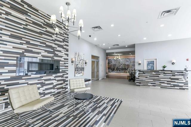 305 Palisade Avenue, Unit 208 Cliffside Park, NJ 07010 - Photo 4 of 16 a living room with furniture and a flat screen tv