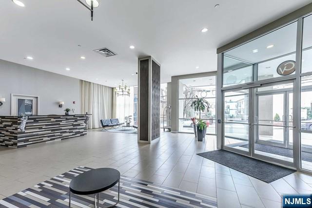 305 Palisade Avenue, Unit 208 Cliffside Park, NJ 07010 - Photo 5 of 16 a living room with furniture and a large window