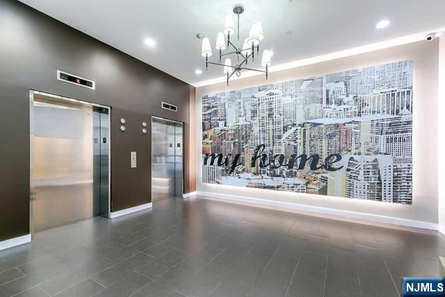 305 Palisade Avenue, Unit 208 Cliffside Park, NJ 07010 - Photo 10 of 16 a view of a glass door and chandelier in a room