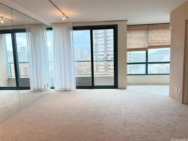 an empty room with windows and closet