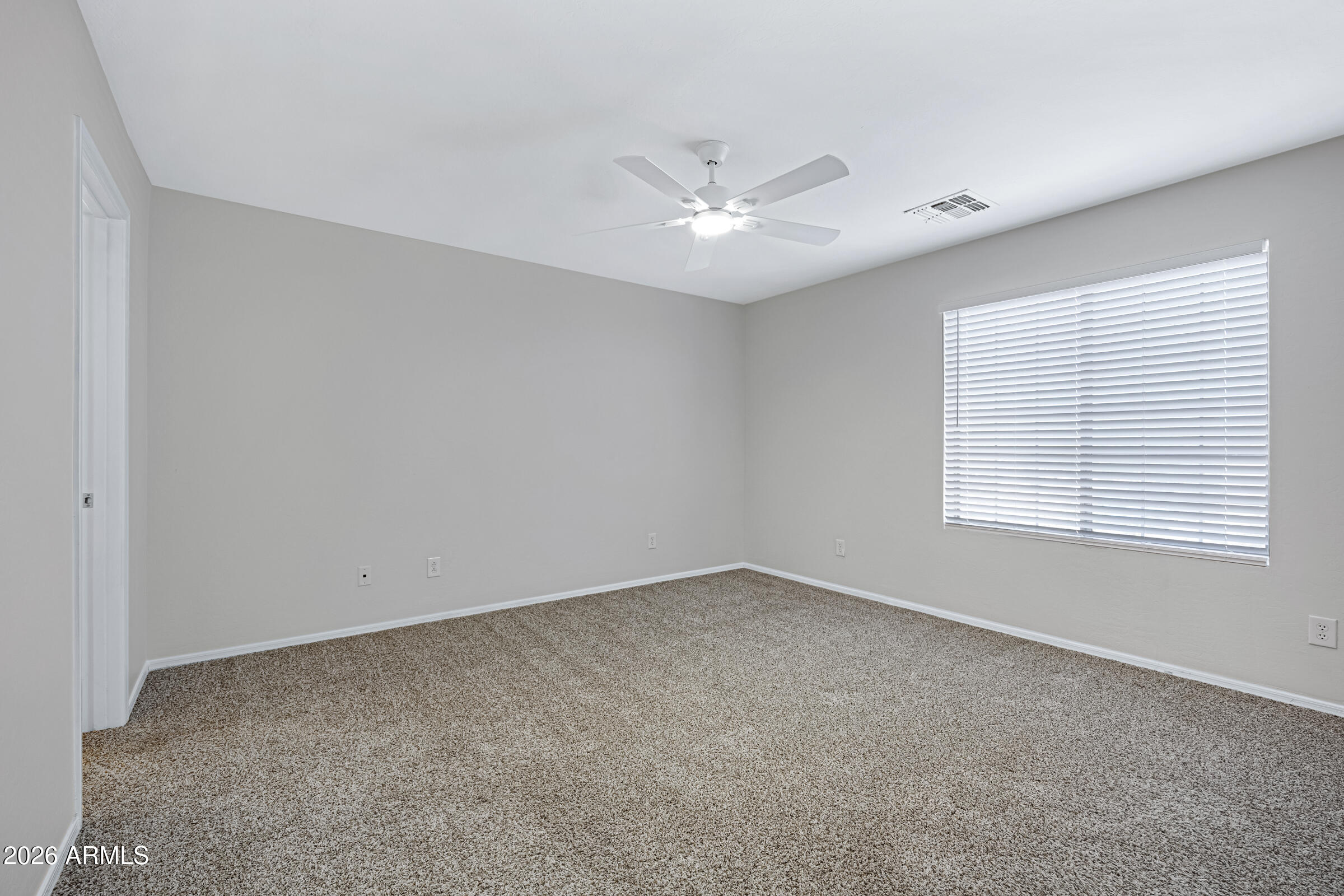 19408 North Braden Road Maricopa, AZ 85138 - Photo 34 of 51 an empty room with a window and a ceiling fan