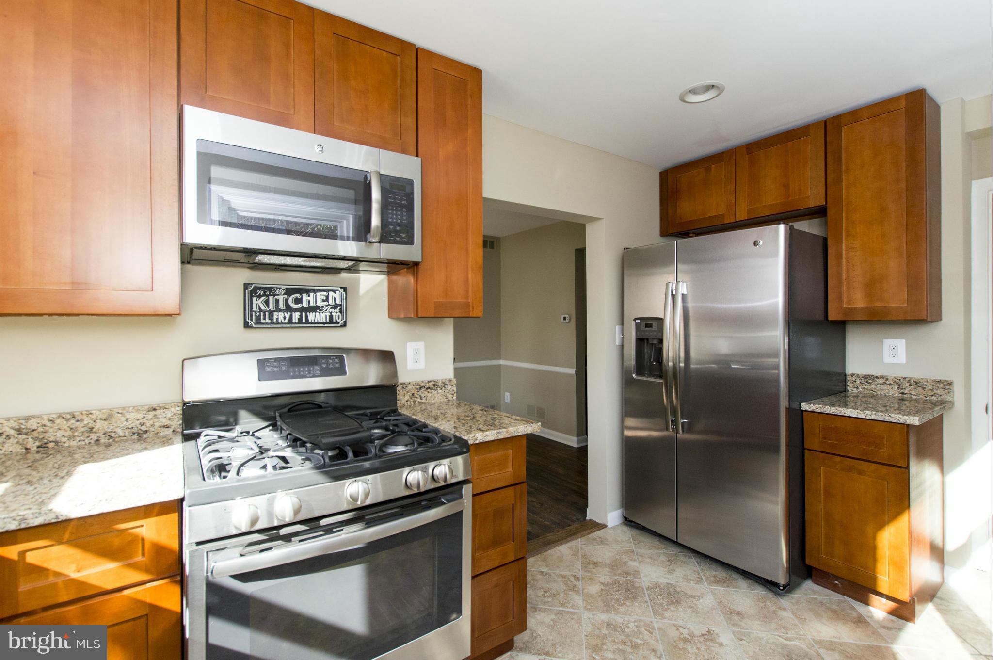 1111 Hollen Road Baltimore, MD 21239 - Photo 1 of 30 a kitchen with stainless steel appliances granite countertop a stove a refrigerator and a microwave