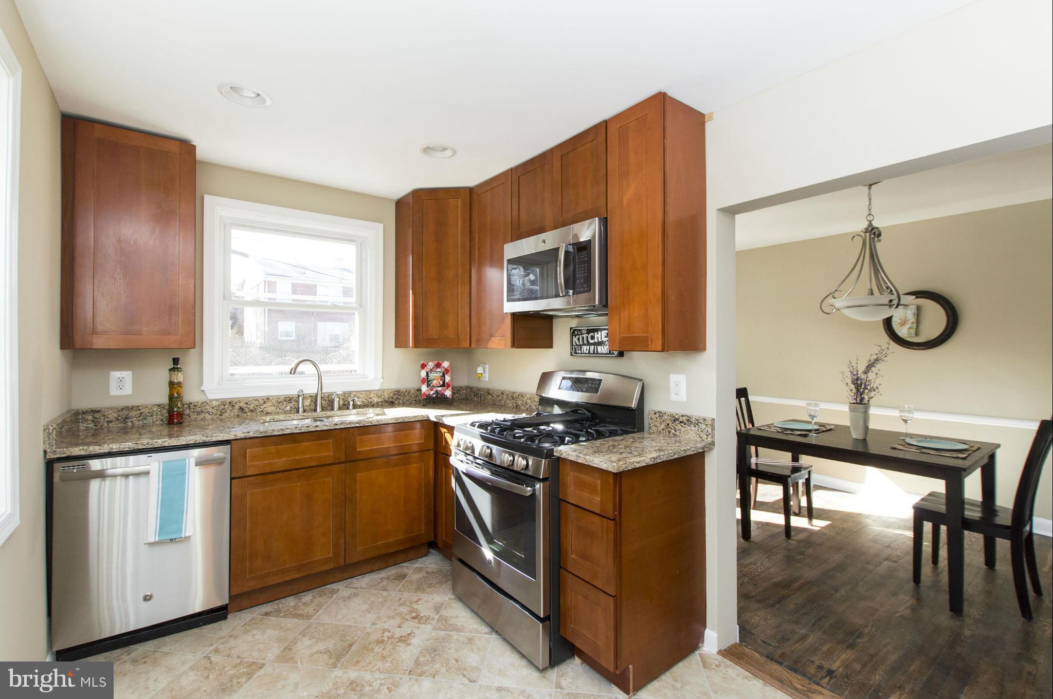 1111 Hollen Road Baltimore, MD 21239 - Photo 2 of 30 a kitchen with stainless steel appliances granite countertop a sink stove and cabinets