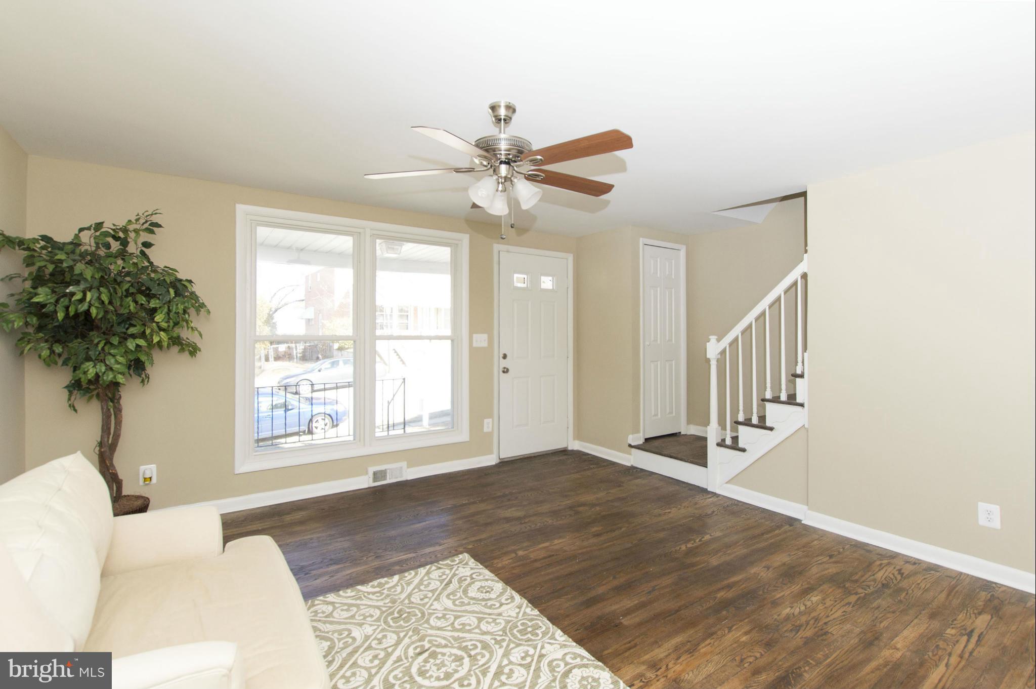 1111 Hollen Road Baltimore, MD 21239 - Photo 11 of 30 a view of an empty room with a window and a chandelier