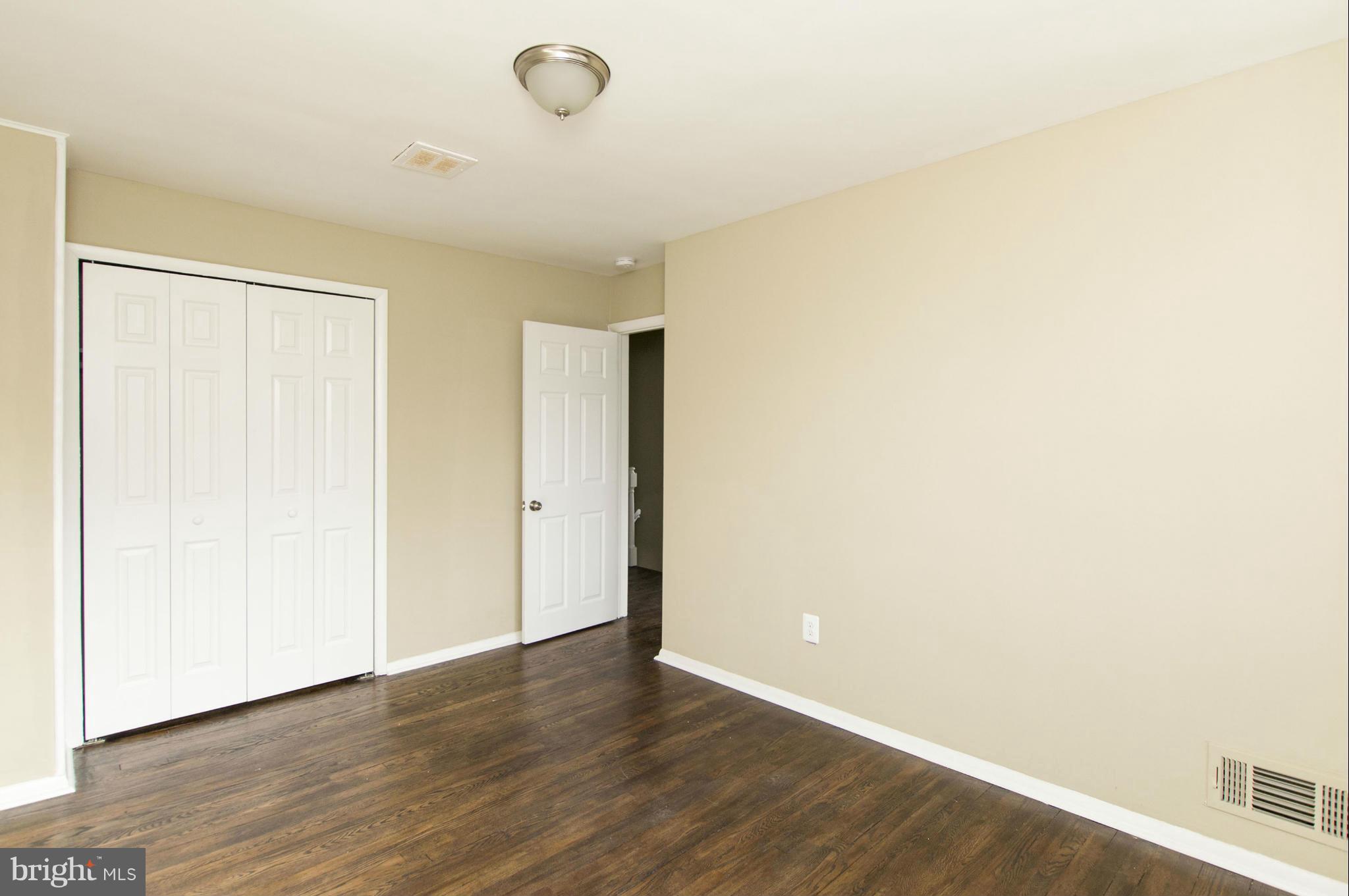 1111 Hollen Road Baltimore, MD 21239 - Photo 19 of 30 a view of an empty room with wooden floor