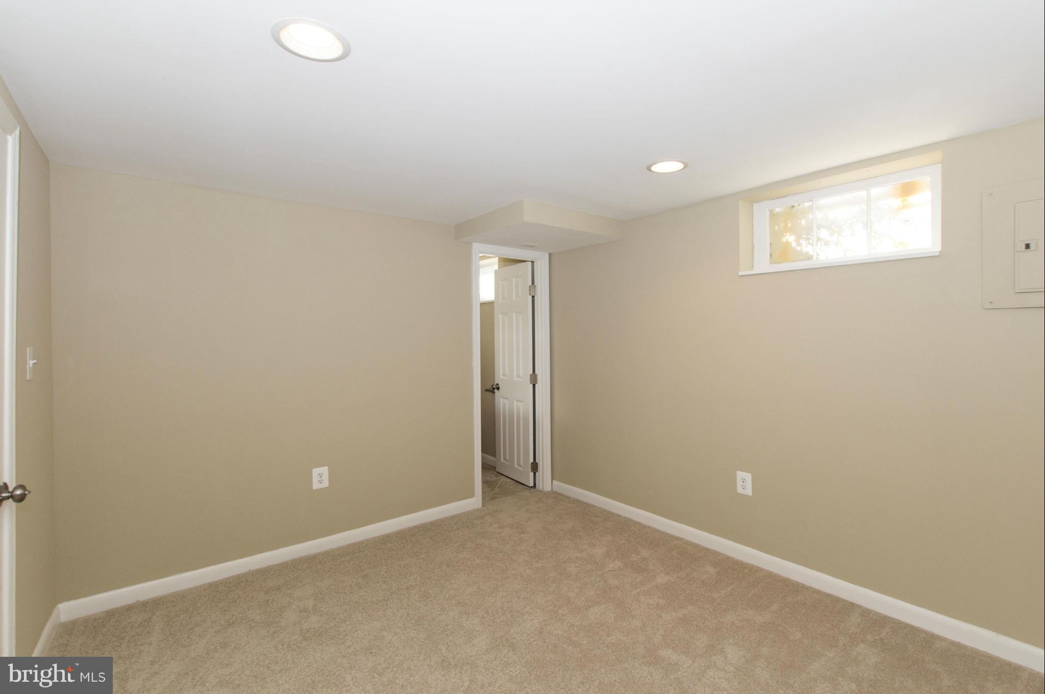 1111 Hollen Road Baltimore, MD 21239 - Photo 22 of 30 an empty room with windows and closet