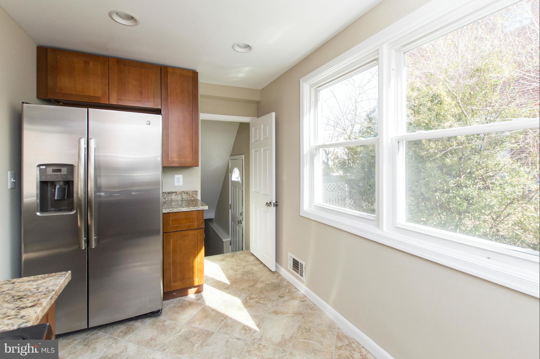 1111 Hollen Road Baltimore, MD 21239 - Photo 5 of 30 a kitchen with stainless steel appliances a refrigerator and a window
