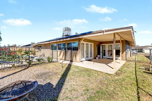 a view of a house with wooden floor and iron fence