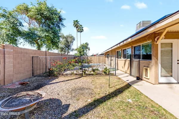 a view of a house with backyard and sitting area