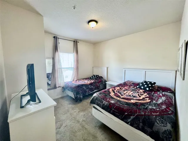 a bedroom with bed and window