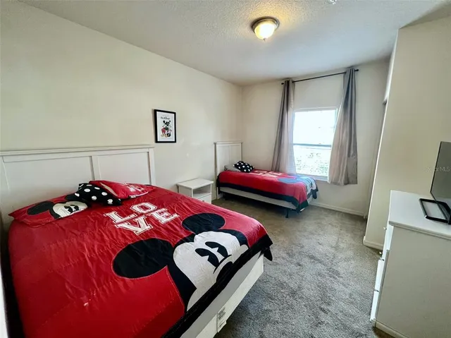 a bedroom with bed and a window