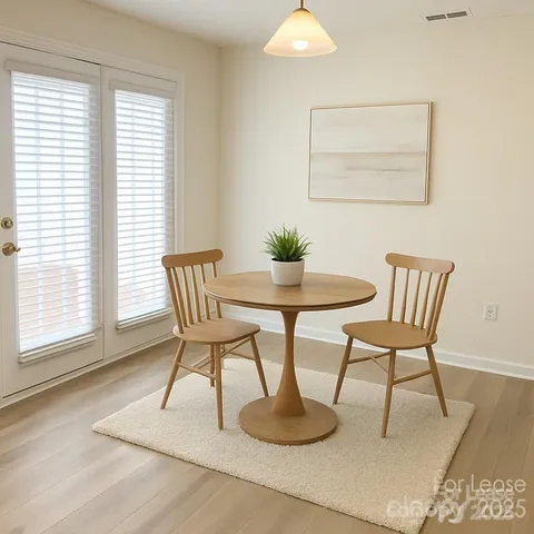 a dining room with furniture and wooden floor