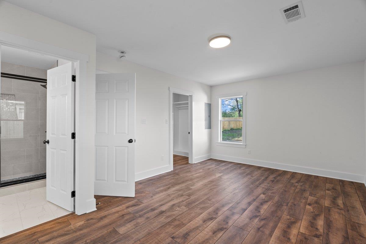 3220 Seminole Road Memphis, TN 38111 - Photo 15 of 23 Unfurnished bedroom featuring dark wood finished floors, a spacious closet, and electric panel