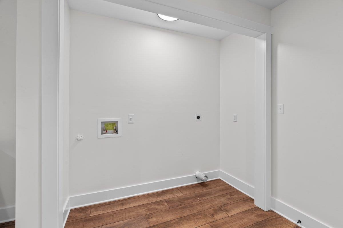 3220 Seminole Road Memphis, TN 38111 - Photo 16 of 23 Laundry room featuring dark wood-style floors, hookup for a washing machine, and hookup for an electric dryer