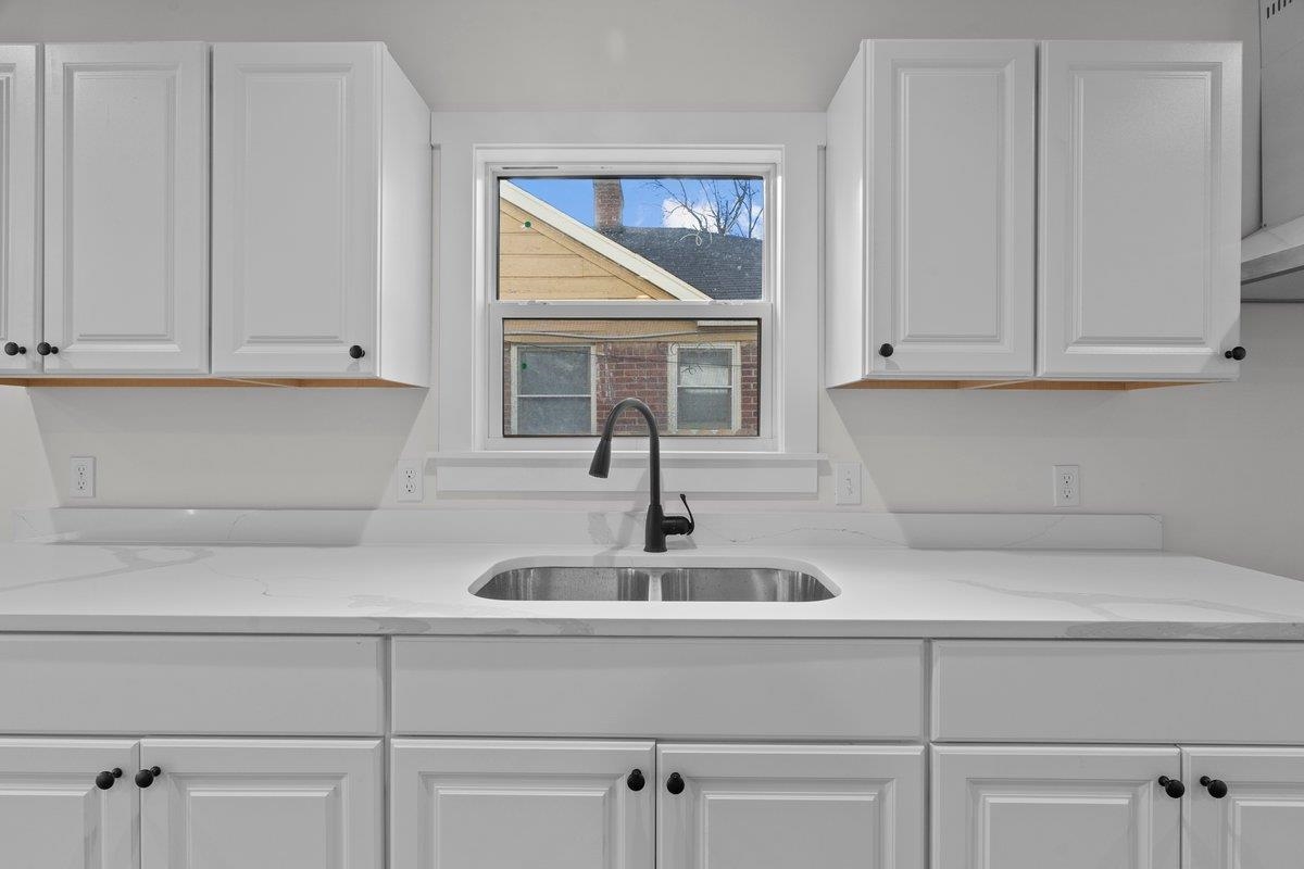 3220 Seminole Road Memphis, TN 38111 - Photo 17 of 23 Kitchen featuring white cabinets and light stone counters