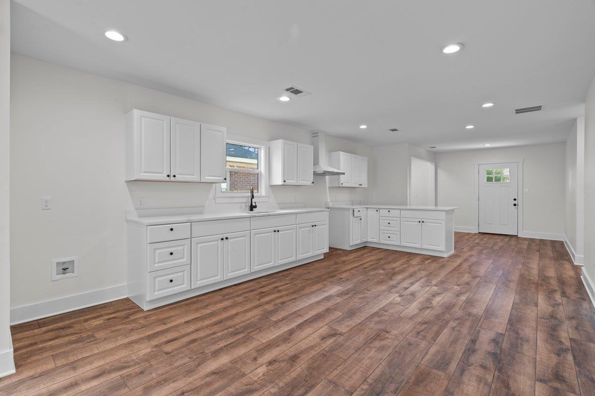 3220 Seminole Road Memphis, TN 38111 - Photo 18 of 23 Kitchen with light countertops, a peninsula, white cabinets, recessed lighting, and dark wood-style flooring