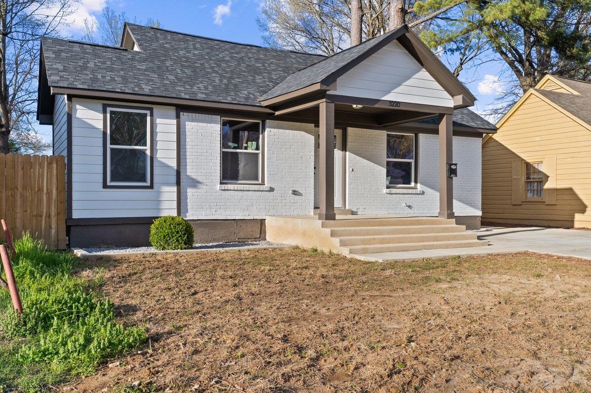 3220 Seminole Road Memphis, TN 38111 - Photo 2 of 23 View of front of house with roof with shingles, covered porch, and brick siding