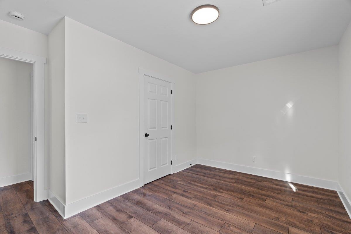 3220 Seminole Road Memphis, TN 38111 - Photo 5 of 23 Unfurnished room with dark wood-style flooring and baseboards