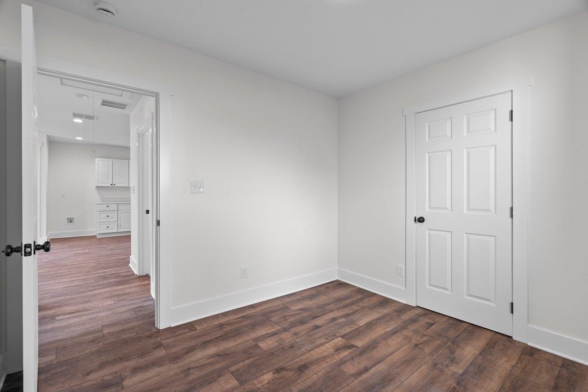 3220 Seminole Road Memphis, TN 38111 - Photo 7 of 23 Unfurnished room featuring baseboards and dark wood finished floors