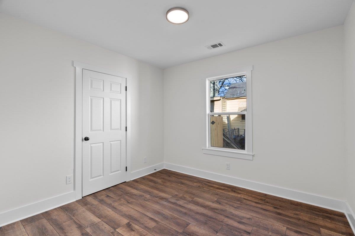 3220 Seminole Road Memphis, TN 38111 - Photo 8 of 23 Unfurnished room featuring baseboards and dark wood-style flooring