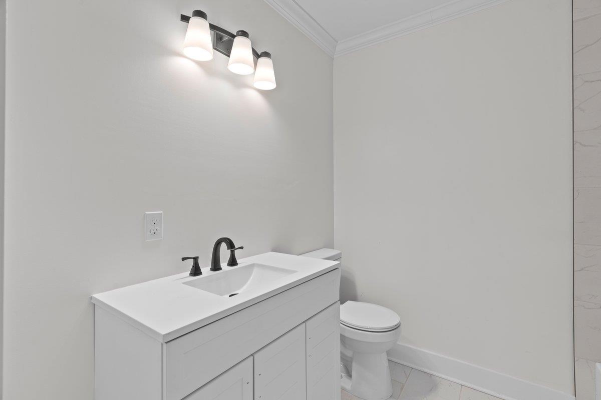 3220 Seminole Road Memphis, TN 38111 - Photo 10 of 23 Bathroom with vanity, crown molding, and light marble finish floors