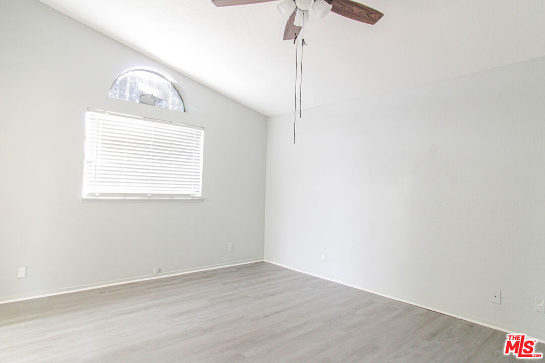 45809 Evelyn Court Lancaster, CA 93534 - Photo 11 of 24 a view of an empty room with wooden floor and a window
