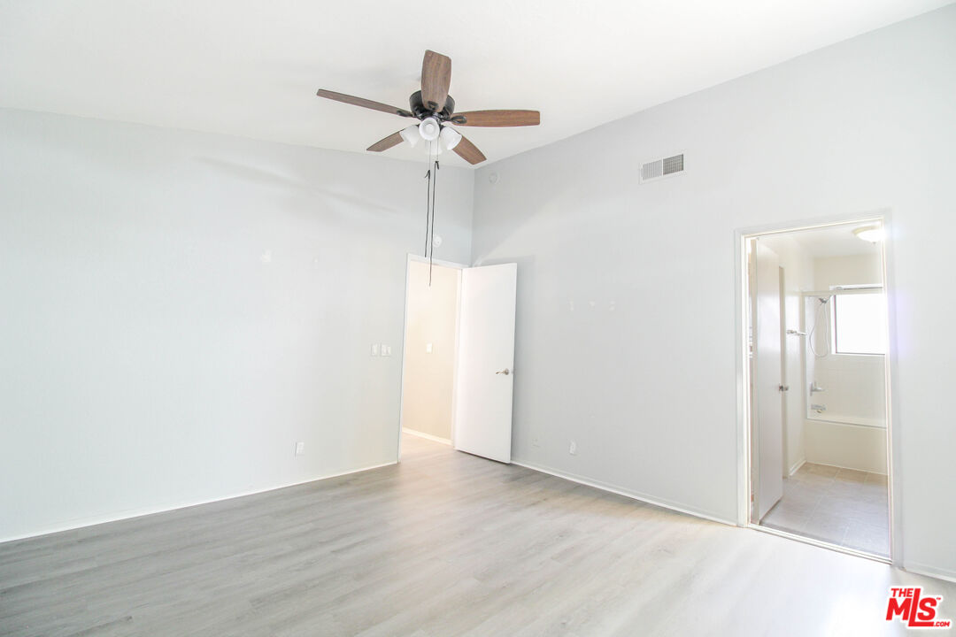 45809 Evelyn Court Lancaster, CA 93534 - Photo 12 of 24 a view of a room with wooden floor and a ceiling fan