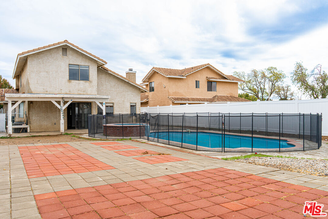 45809 Evelyn Court Lancaster, CA 93534 - Photo 20 of 24 a view of a house with a backyard and a garage