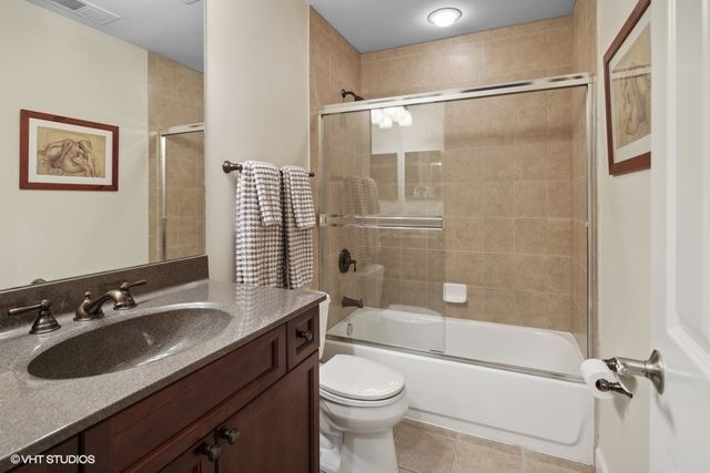 a bathroom with a sink toilet tub and shower