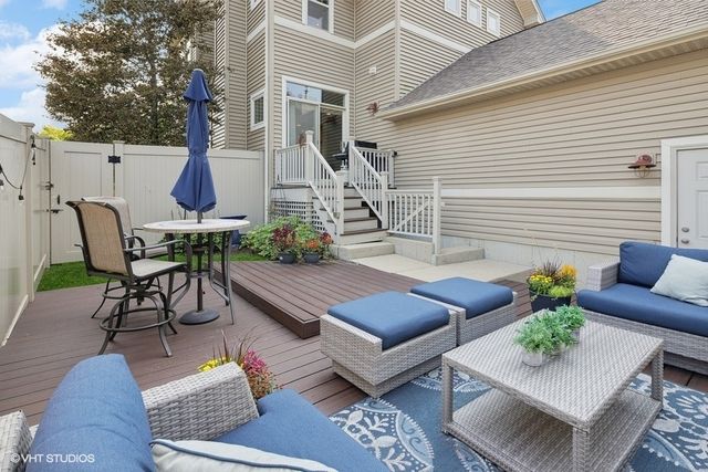 a view of patio with couches table and chairs and potted plants