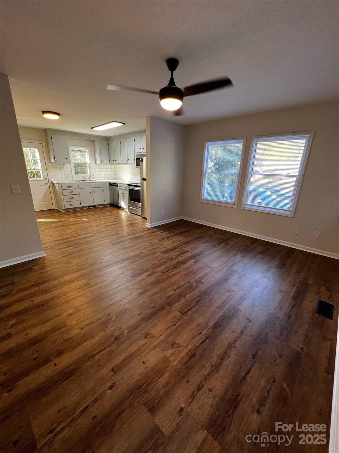 120 South Morrow Avenue Albemarle, NC 28001 - Photo 3 of 6 an empty room with wooden floor and windows