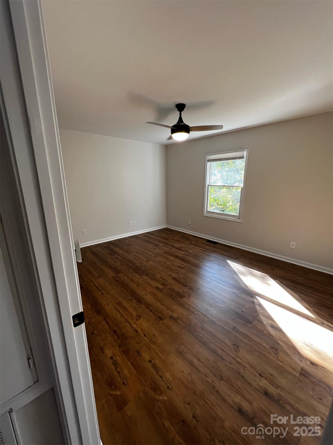 120 South Morrow Avenue Albemarle, NC 28001 - Photo 4 of 6 a view of empty room with window and wooden floor