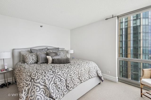 a bedroom with a large bed and a window