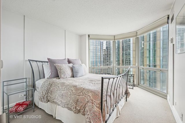 a bedroom with a bed and a large window