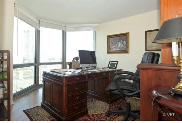 a view of a workspace with furniture and a window