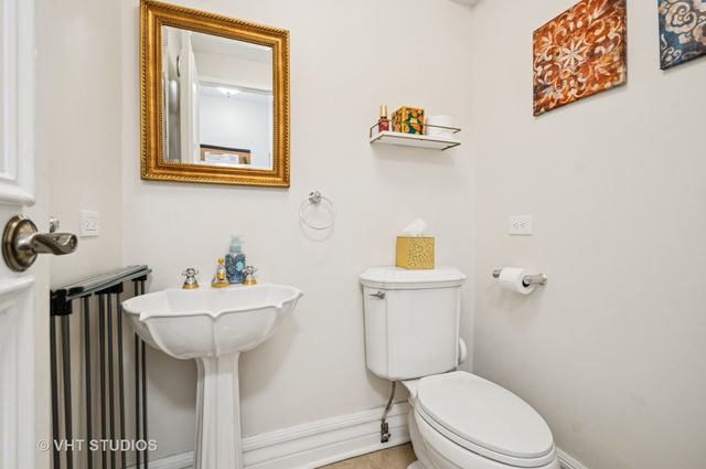 a bathroom with a toilet sink and mirror