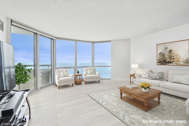 a living room with furniture and large windows