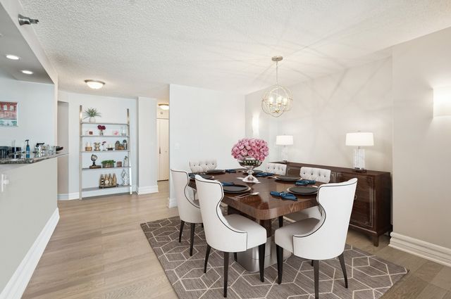 a view of a dining room with furniture and chandelier