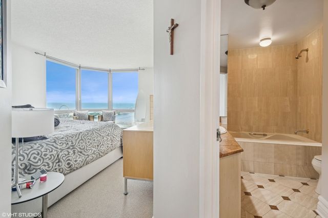 a bathroom with a granite countertop sink and a shower