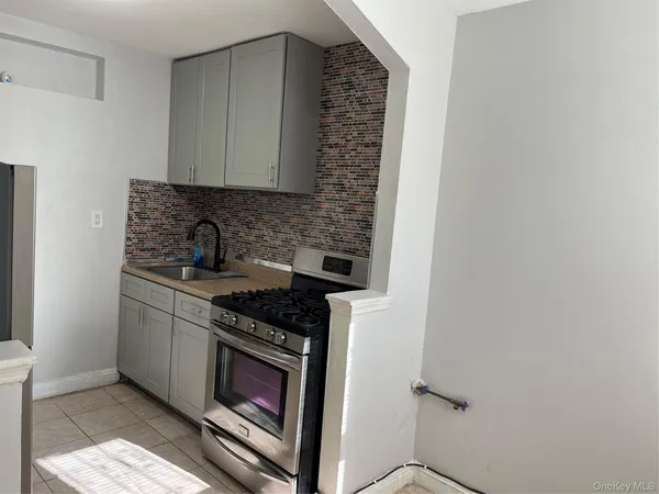 a kitchen with stainless steel appliances granite countertop a stove and a sink